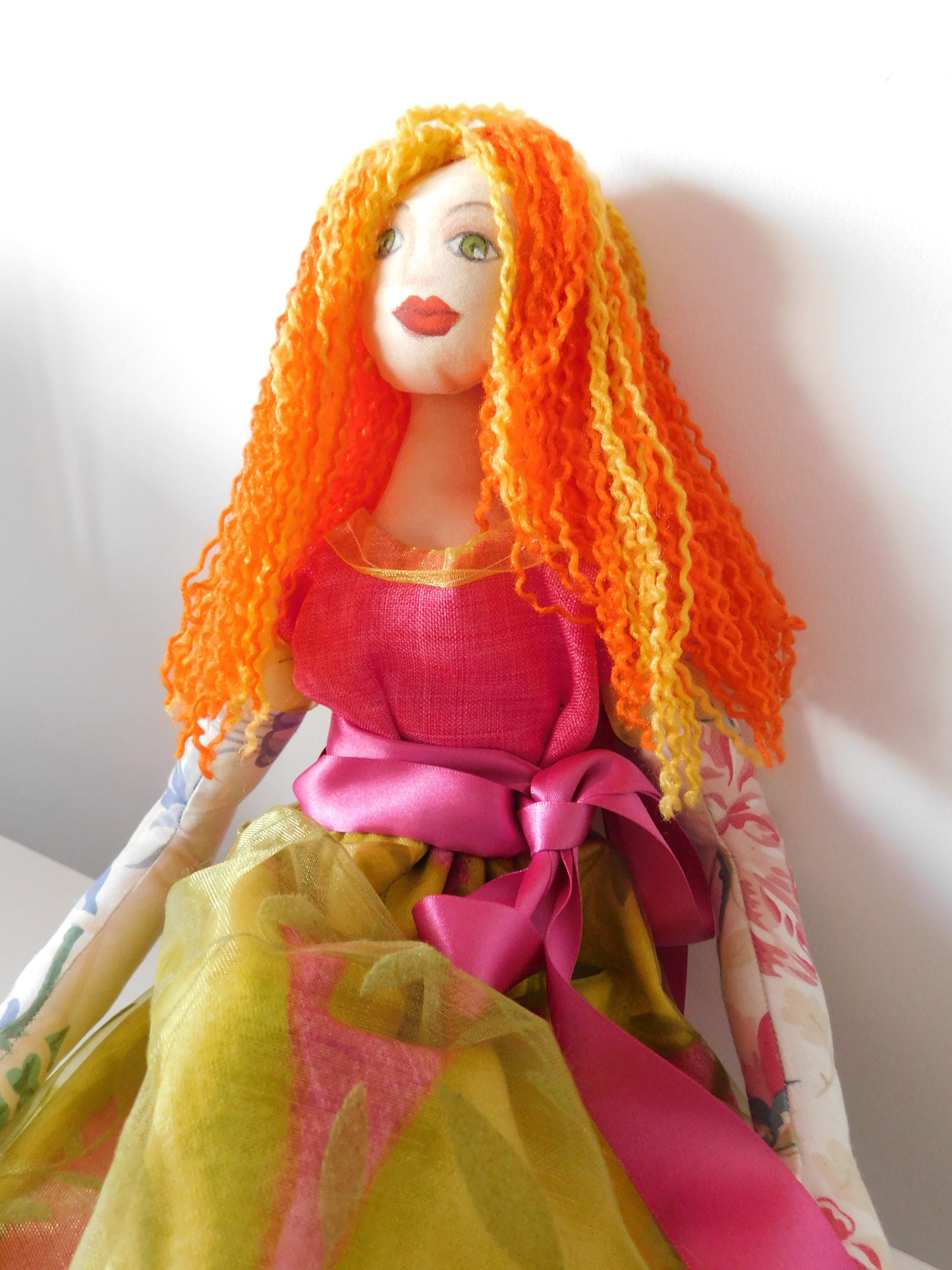 soft fabric doll with pink and green dress