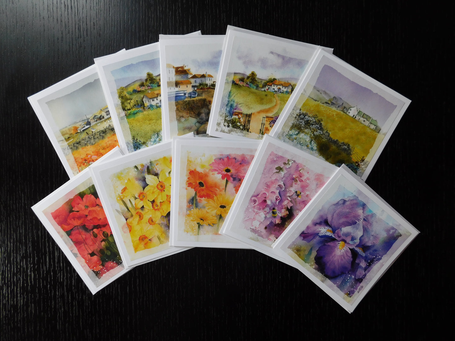 Collection of watercolor cards with various landscapes and floral designs
