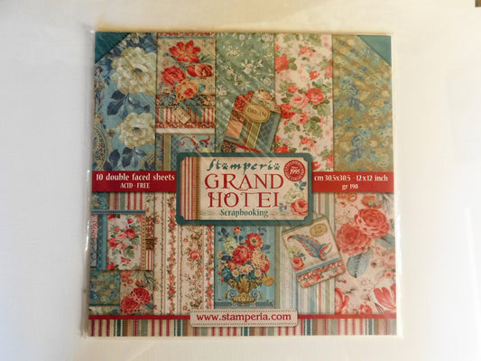 A packaged scrapbook paper set titled 'Grand Hotel' by Stamperia, featuring a collage of vintage floral and striped patterns in muted teal, red, cream, and brown tones, sealed in plastic on a white background.