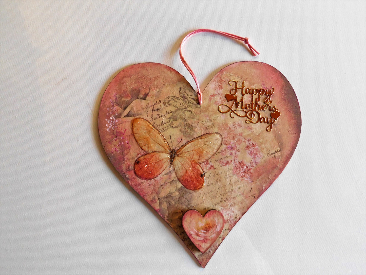Heart-shaped wooden card with butterfly design and 'Happy Mother's Day' text on a light background