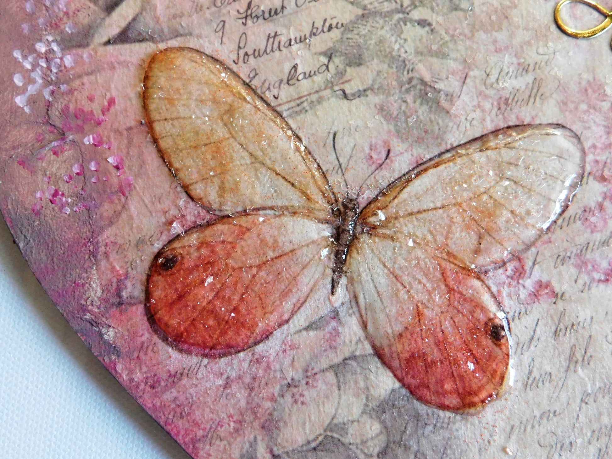 Butterfly with pink and brown wings on a textured pink background created with Stamperia 3D medium