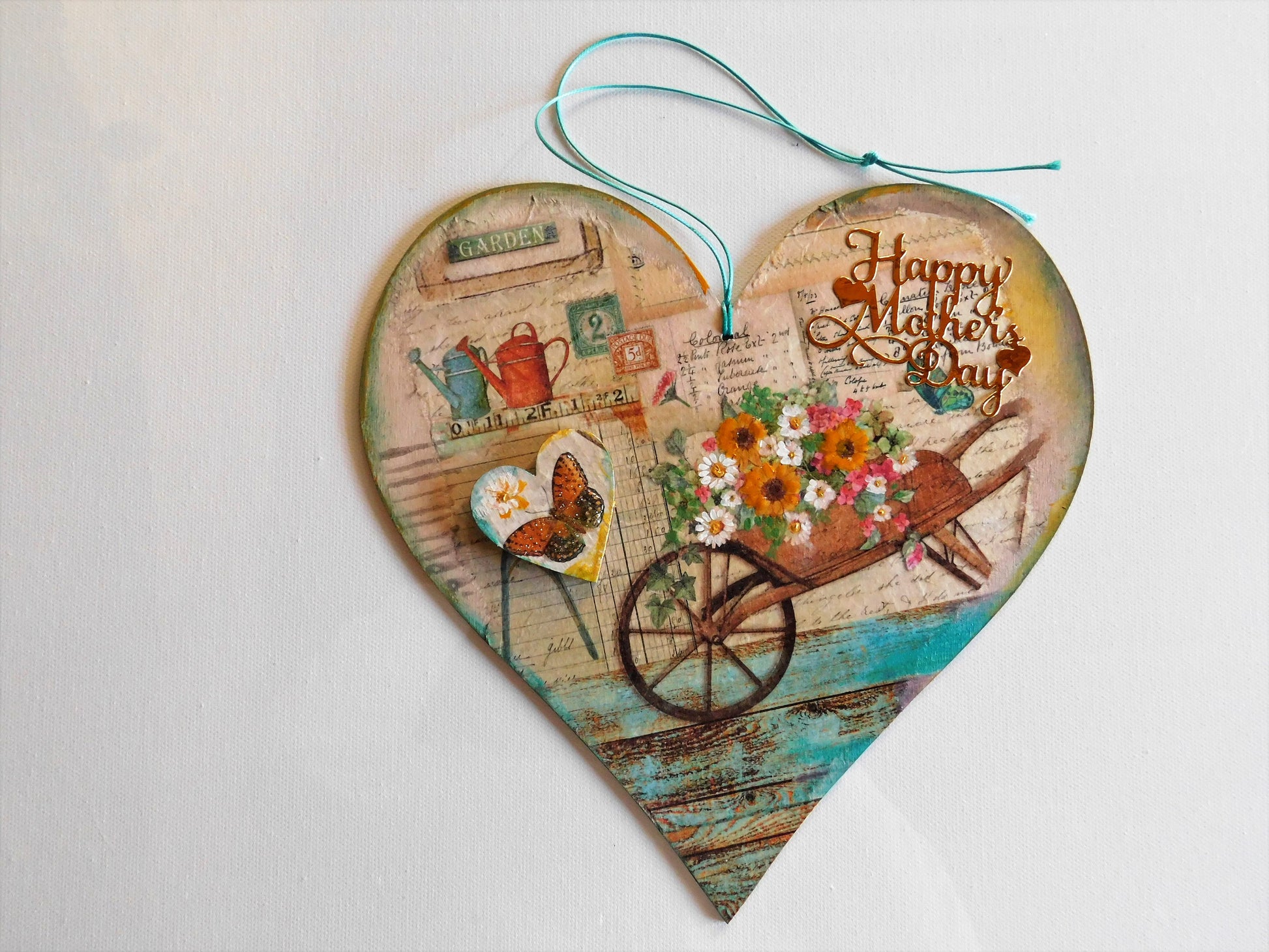 Heart-shaped wooden card with 'Happy Mother's Day' text and floral design on a white background