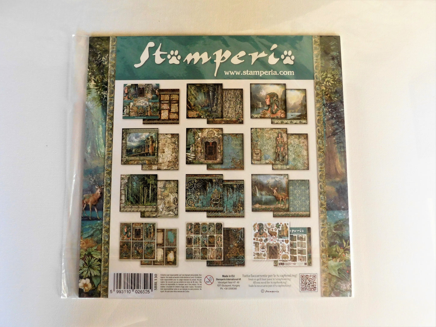 A packaged Stamperia scrapbooking paper sheet in a clear plastic sleeve, showing a grid of vintage-style illustrated cards and borders on a white background.