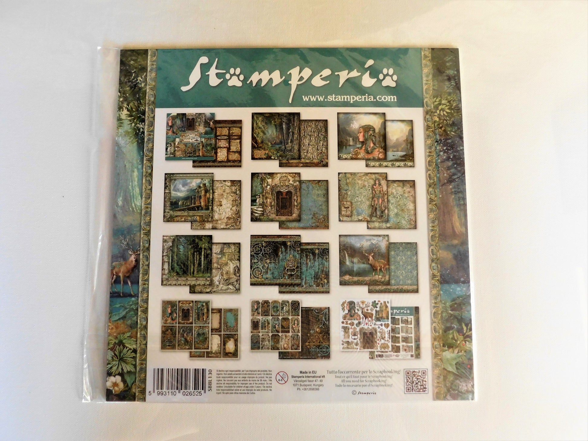 A packaged Stamperia scrapbooking paper sheet in a clear plastic sleeve, showing a grid of vintage-style illustrated cards and borders on a white background.