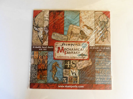 A square scrapbooking paper sheet set in plastic wrapping, featuring a vintage mechanical and industrial collage design with red, blue, beige, and brown tones, labeled 'Stamperia Mechanical Fantasy'.