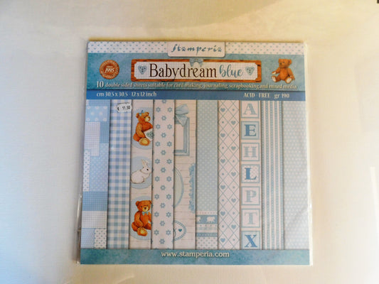 A package of Stamperia Babydream Blue scrapbooking paper, featuring 10 double-sided sheets with various blue patterns, stripes, and teddy bear illustrations.
