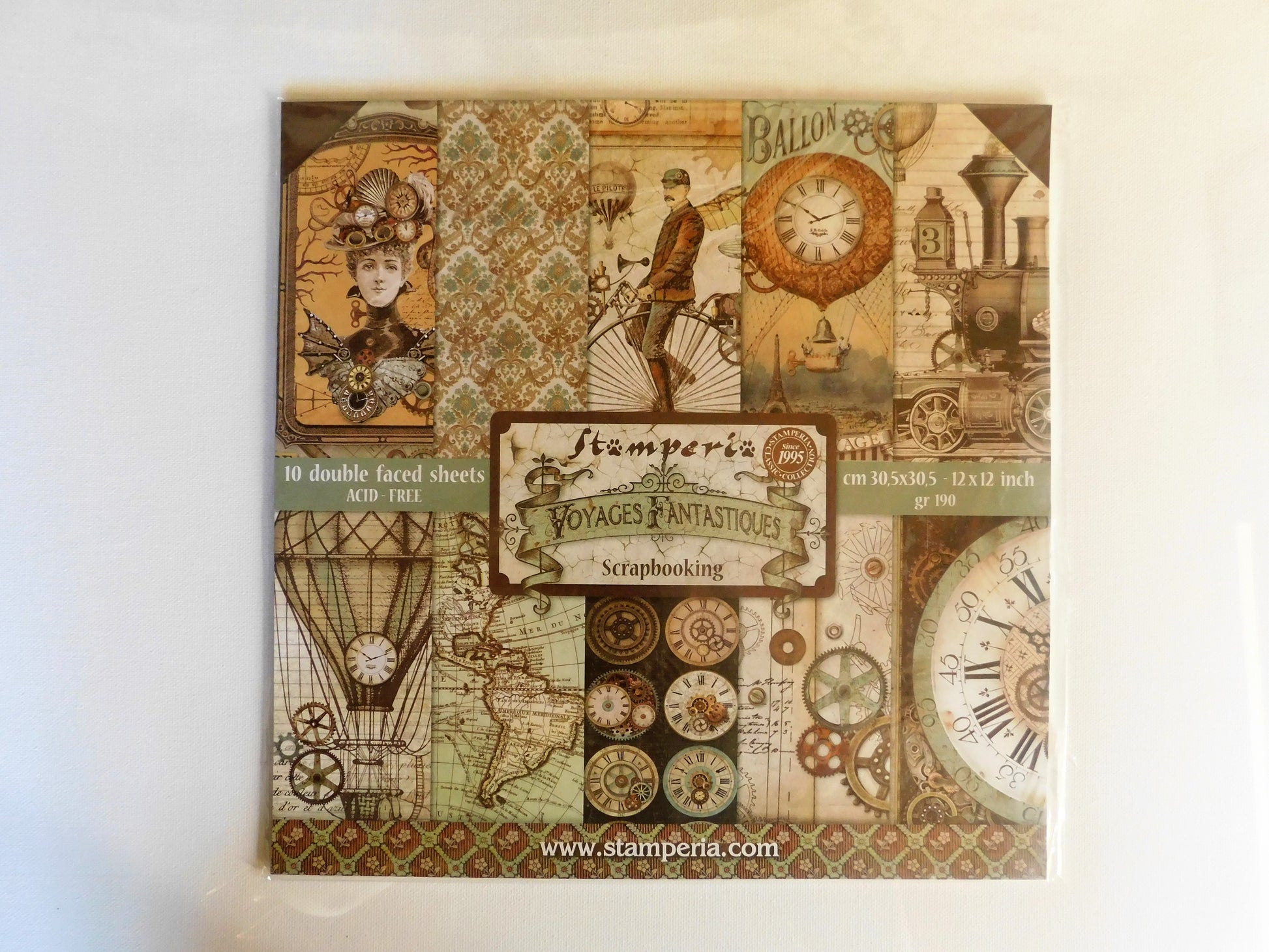 A  scrapbooking paper pad  from Stamperia's 'Voyages Fantastiques' collection, featuring a vintage steampunk collage design with clocks, hot air balloons, gears, and a woman in a steampunk outfit.