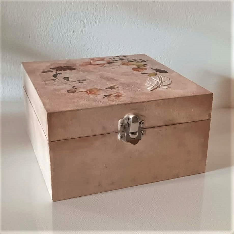 hand crafted romantic  wooden box with floral design on a plain background