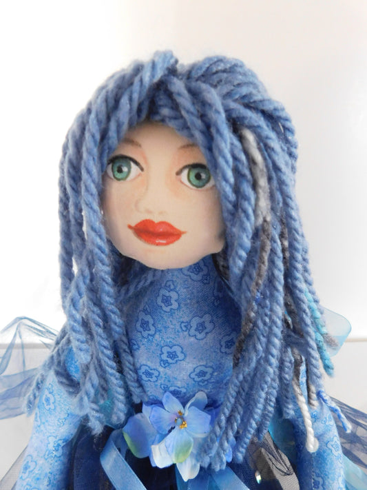 Hand=painted cloth doll in blue colors