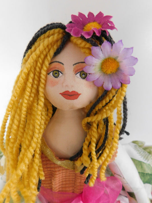 colorful handmade fabric doll with yellow and dark blue hair made of wool